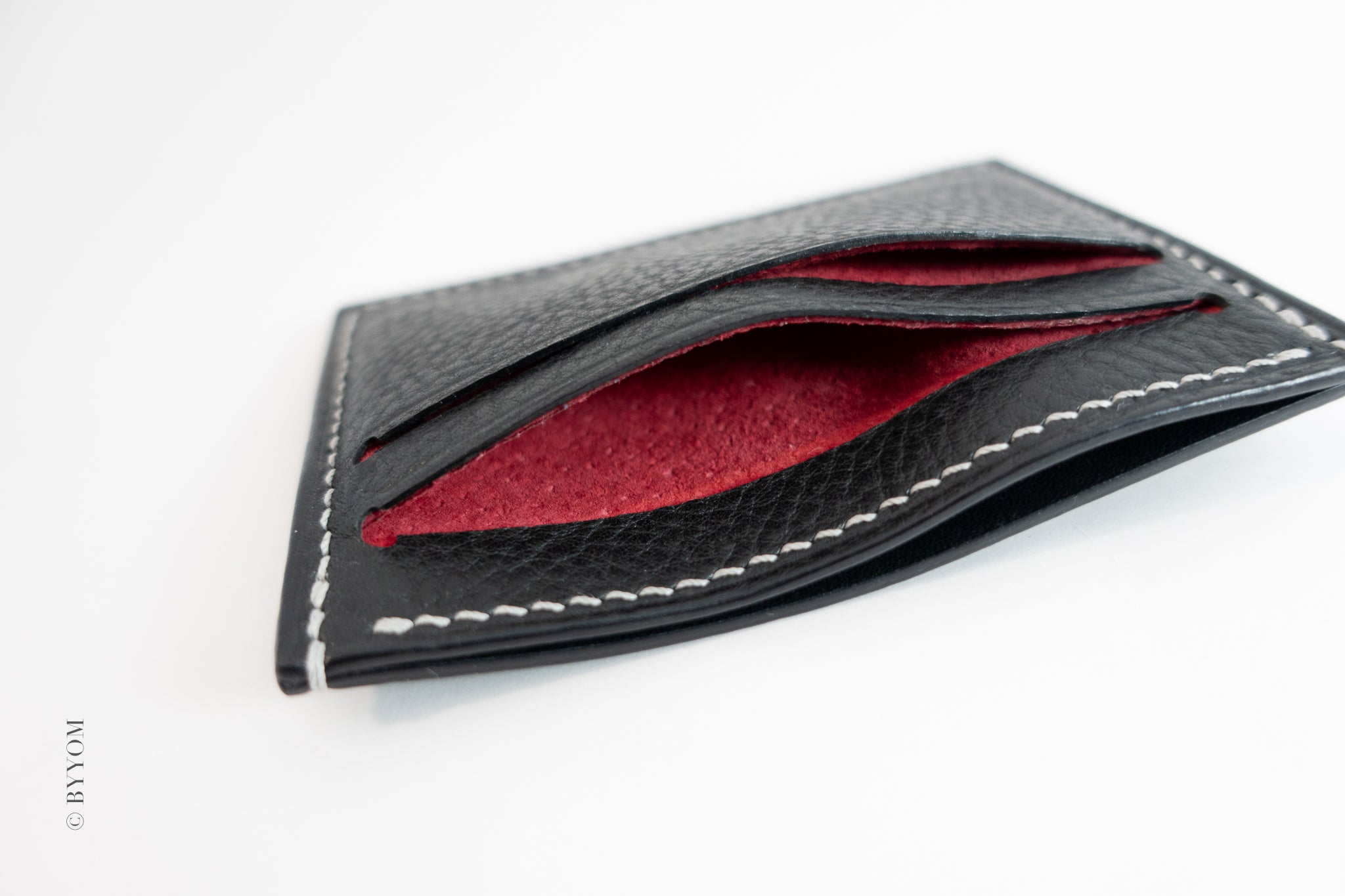 Alan goat skin wallet with red pig skin interior on a white background
