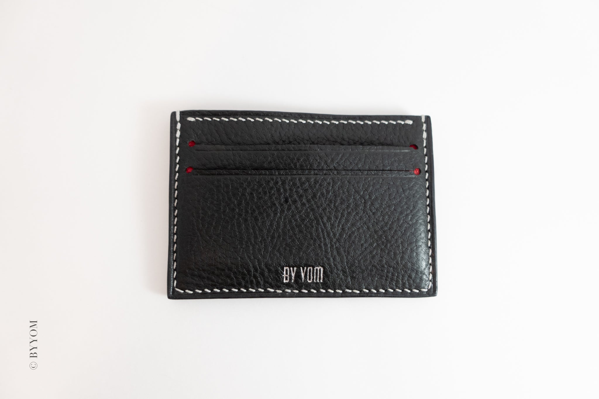 Alan goat skin cardholder with white stitch made 'BY VOM' branding on a white background